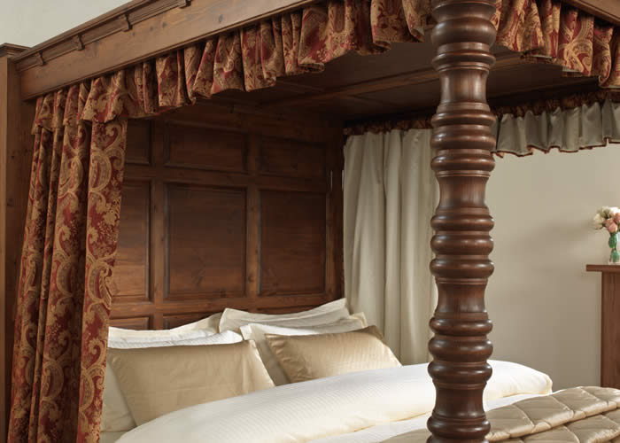 Traditional Red and Gold Drapes on Four Poster Bed