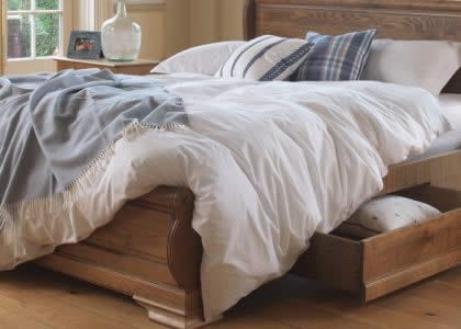 White Bedding and Underbed Storage on Sleigh Bed