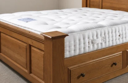 Tufted mattress on a solid wooden bed in a bedroom